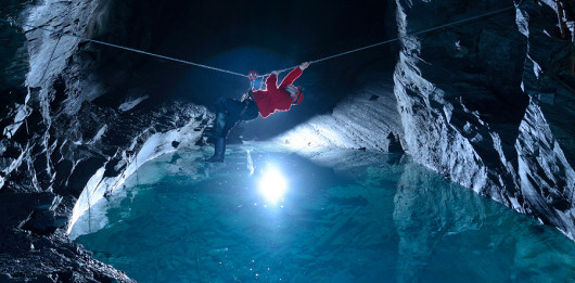 an explorer ziplining over water