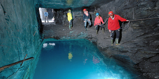 Explorers peering into a deep pool